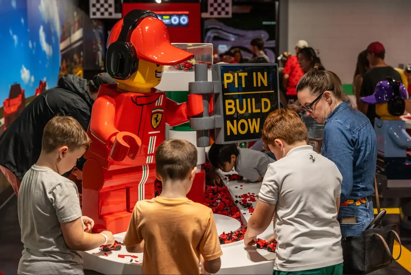 LEGOLAND Florida Itinerary for Toddlers vs. Pre-Teens 4 Children building LEGO cars at Ferrari Build and Race at LEGOLAND Florida
