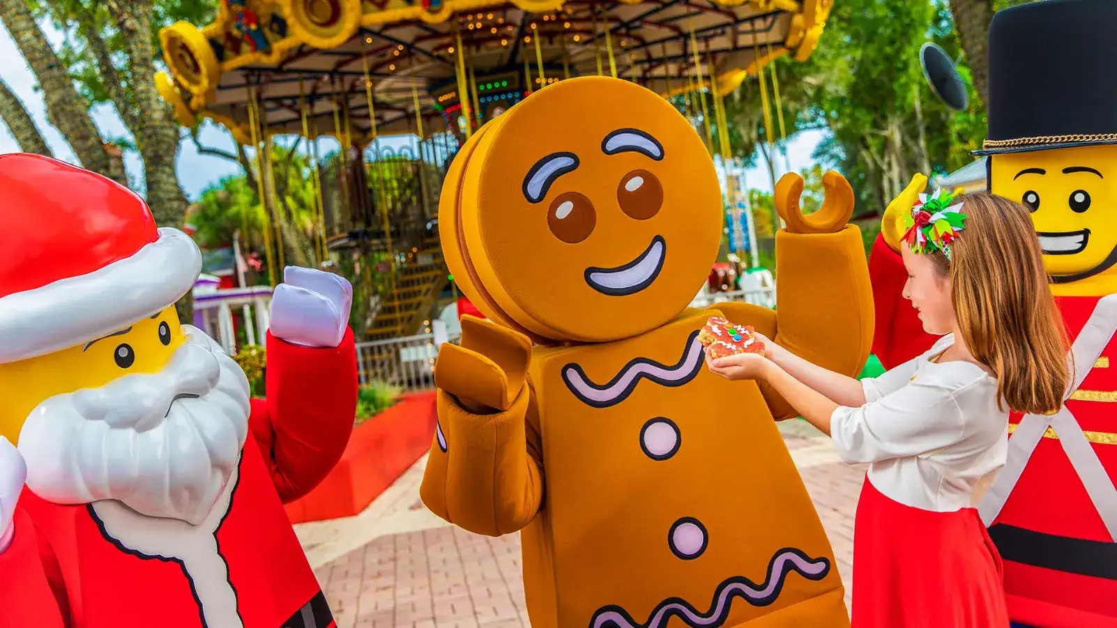 LEGOLAND Florida Winter Holiday Planning Guide 2026 1 Children meeting LEGO Santa and a gingerbread character at LEGOLAND Florida