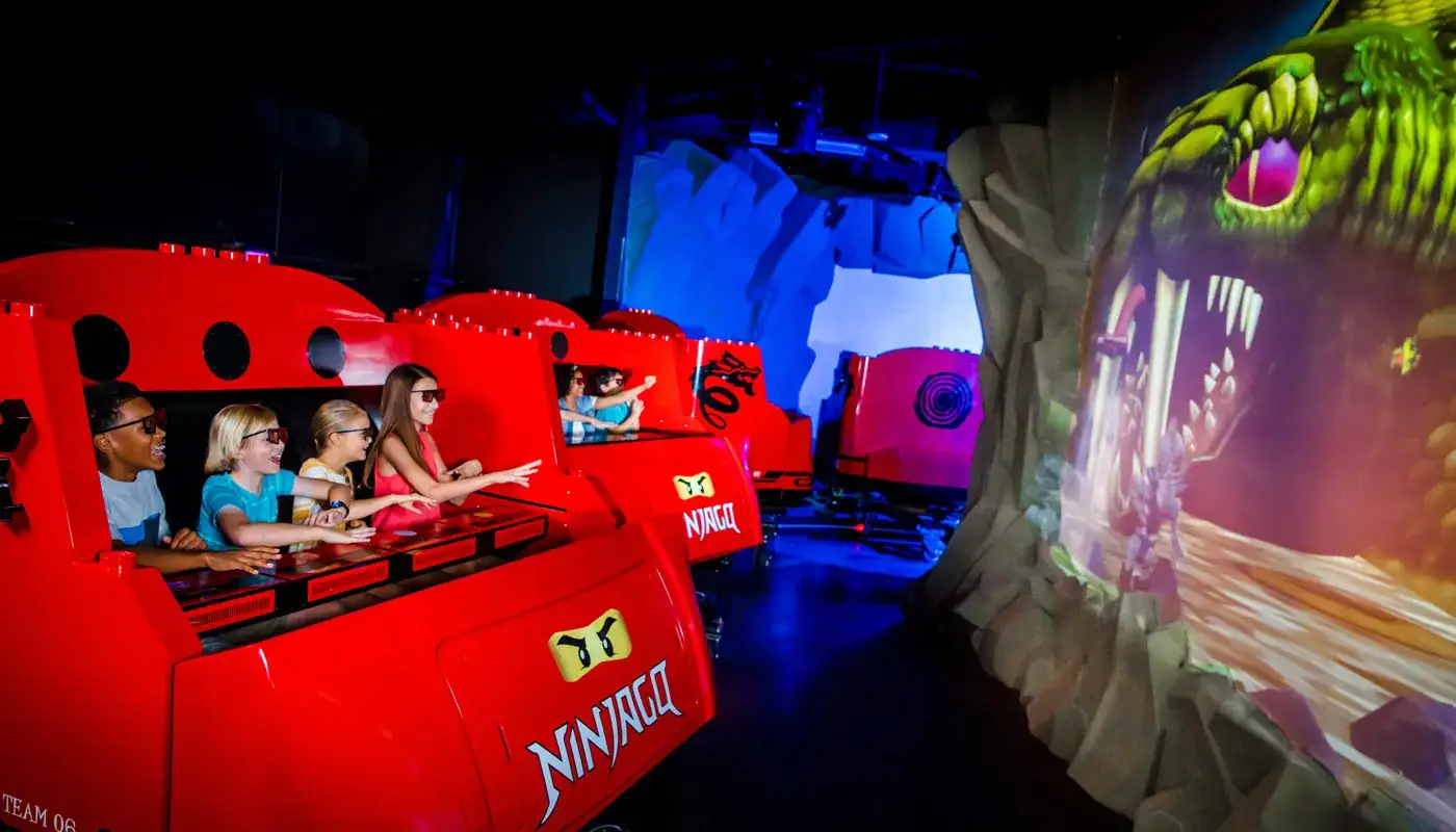 LEGOLAND Florida Itinerary for Toddlers vs. Pre-Teens 5 Riders using hand gestures on LEGO NINJAGO The Ride at LEGOLAND Florida