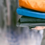 LEGOLAND Florida: A person holding a stack of clothes in a closet.