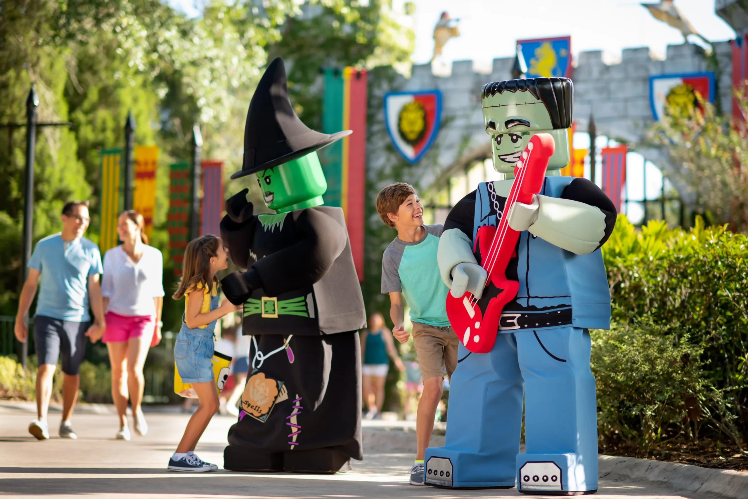 New for 2026: Brick or Treat Street at LEGOLAND Florida 2 Children meeting LEGO Witch and Frankenstein monster characters at LEGOLAND Florida