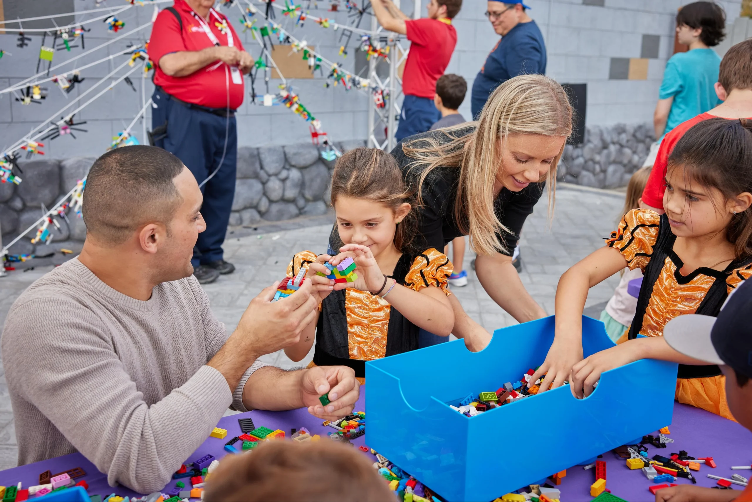New for 2026: Brick or Treat Street at LEGOLAND Florida 4 Children in orange and black costumes building with LEGO bricks at a table