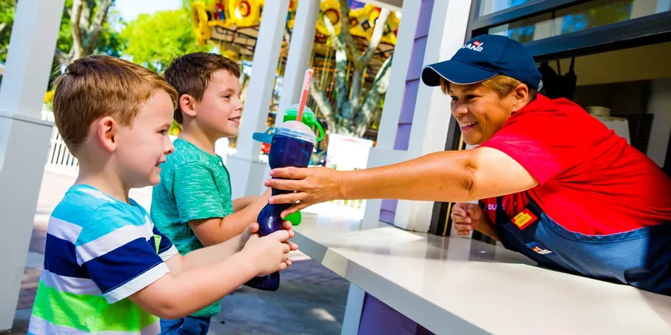 LEGOLAND Florida Summer Planning Guide 2026 7 Kids receiving colorful frozen drinks at LEGOLAND Florida